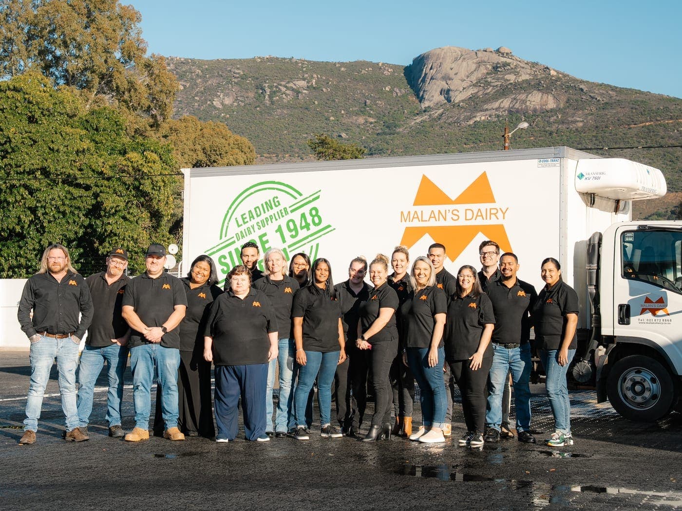 The full Malan's Dairy team in front of a branded truck in Paarl