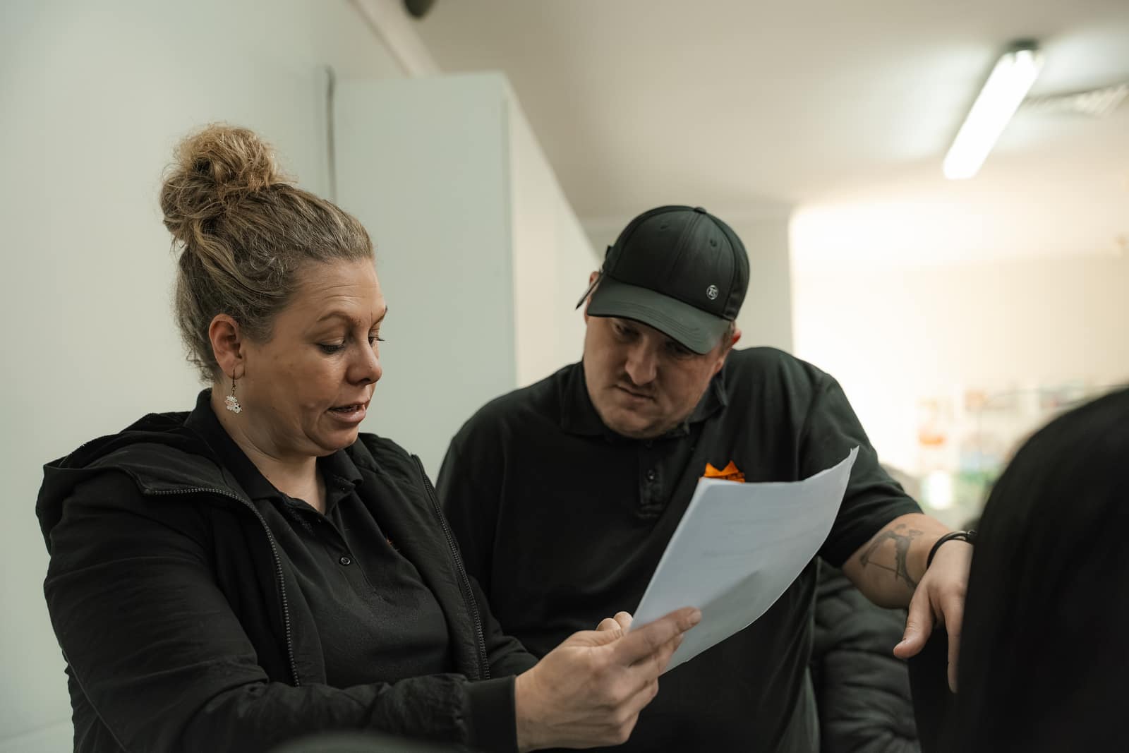 Two Malan's Dairy colleagues checking an order sheet together