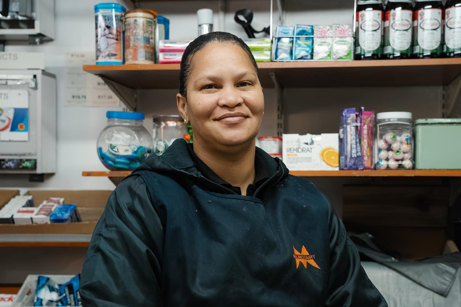 A Malan's Dairy Factory Shop assistant smiling behind the counter