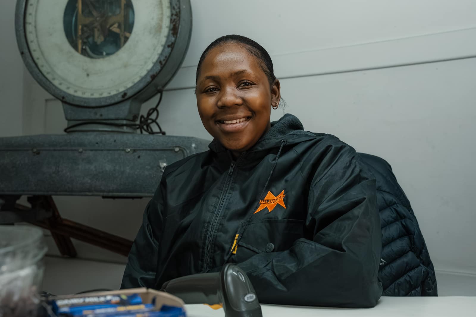 A smiling Malan's Dairy Factory Shop assistant at the counter