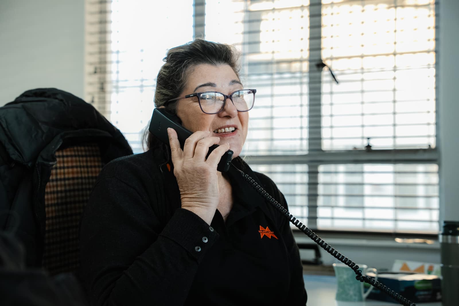 A Malan's Dairy telesales rep taking an order on the phone at her desk