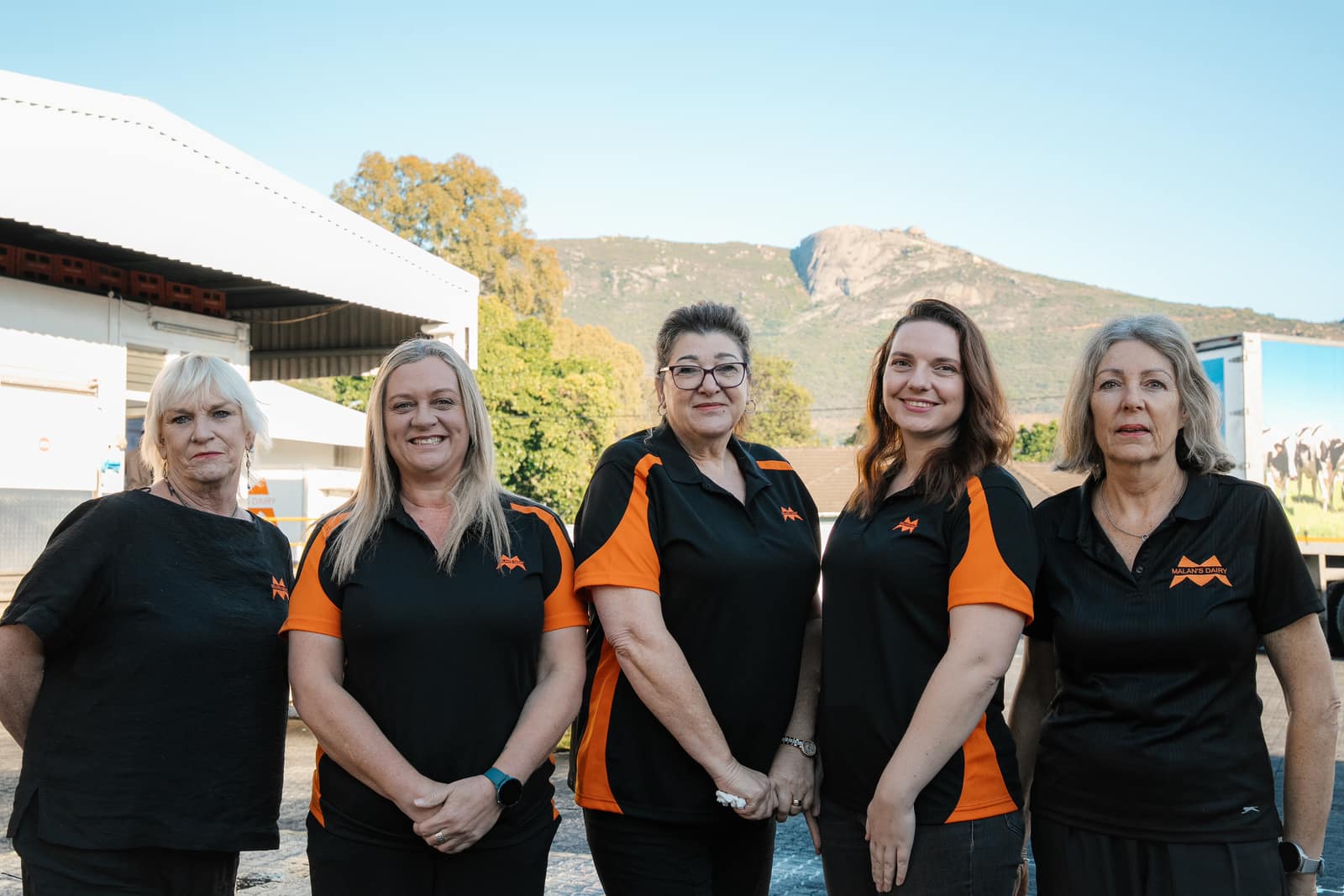 The Malan's Dairy sales and telesales team with Paarl Rock behind them