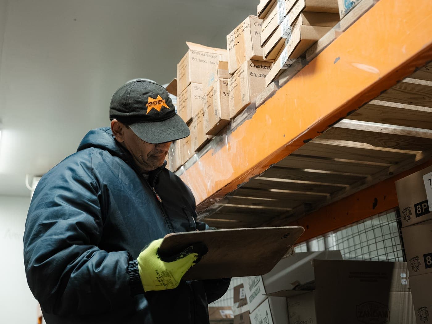 A Malan's Dairy team member checking stock inside the cold room